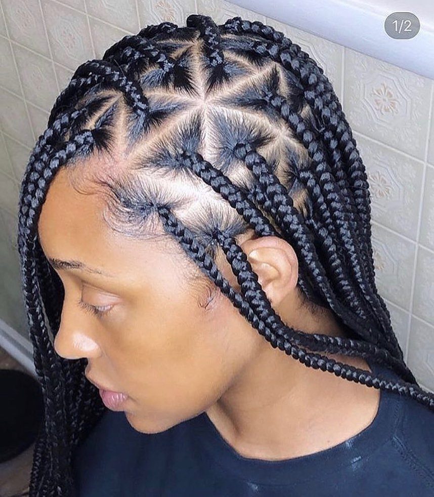 Black triangle-part braids flow past a person’s shoulders