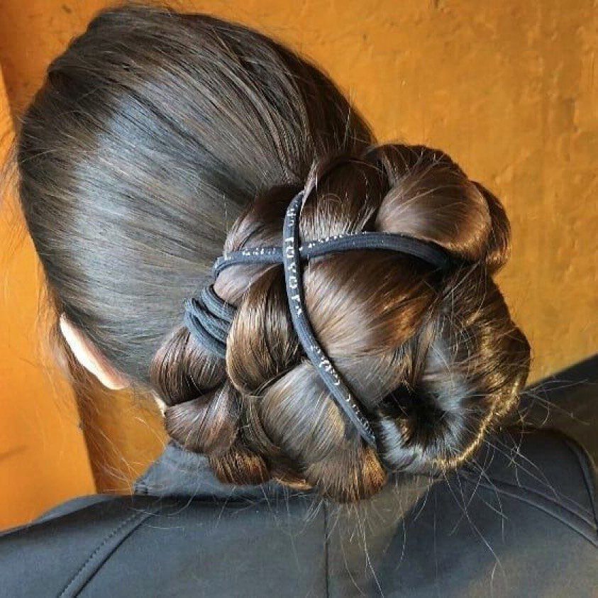 Braided bun hairstyle viewed from behind with glossy brown hair