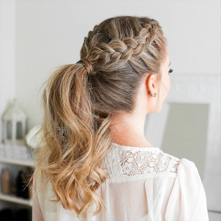 Woman with braided crown and long wavy blonde ponytail hairstyle