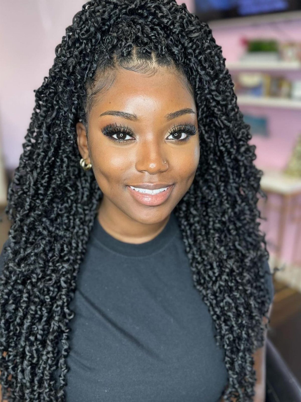 Woman with long, black crochet twists styled into dense, defined curls