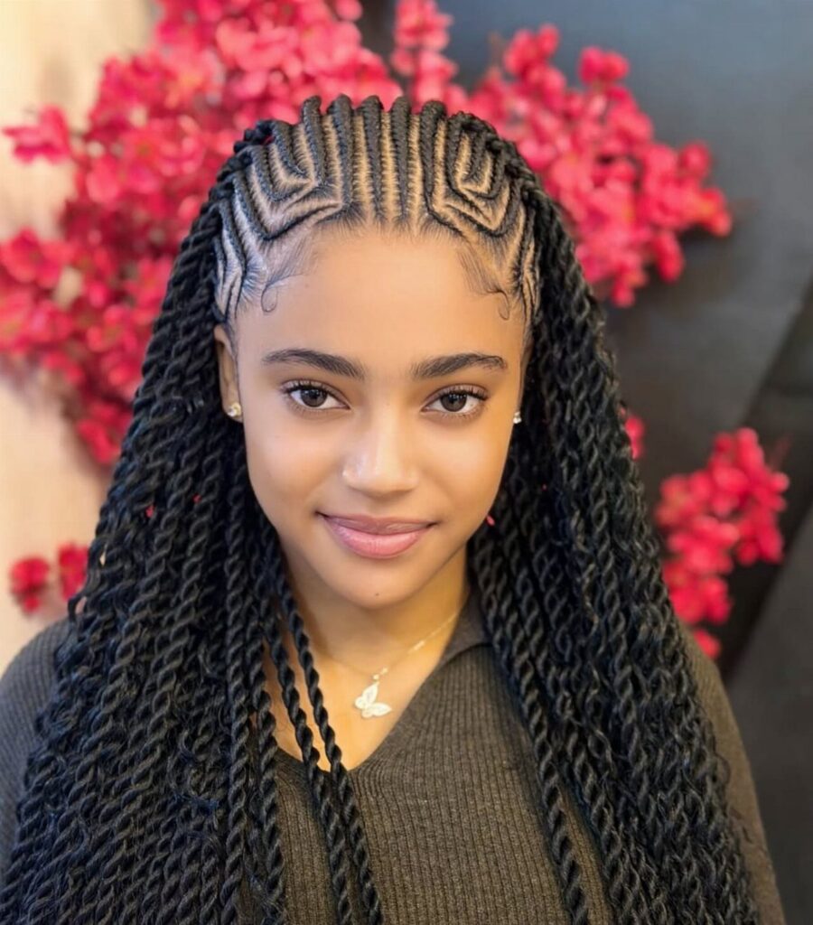 Young woman displaying long braids and geometric cornrows against pink flowers