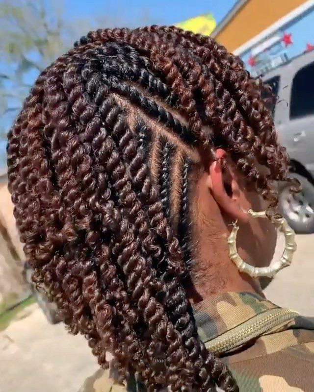 Natural hair styled in glossy two-strand twists with precise scalp partings