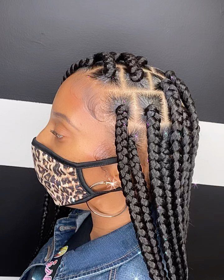 Person displaying medium box braids with neat square parting and leopard-print face mask