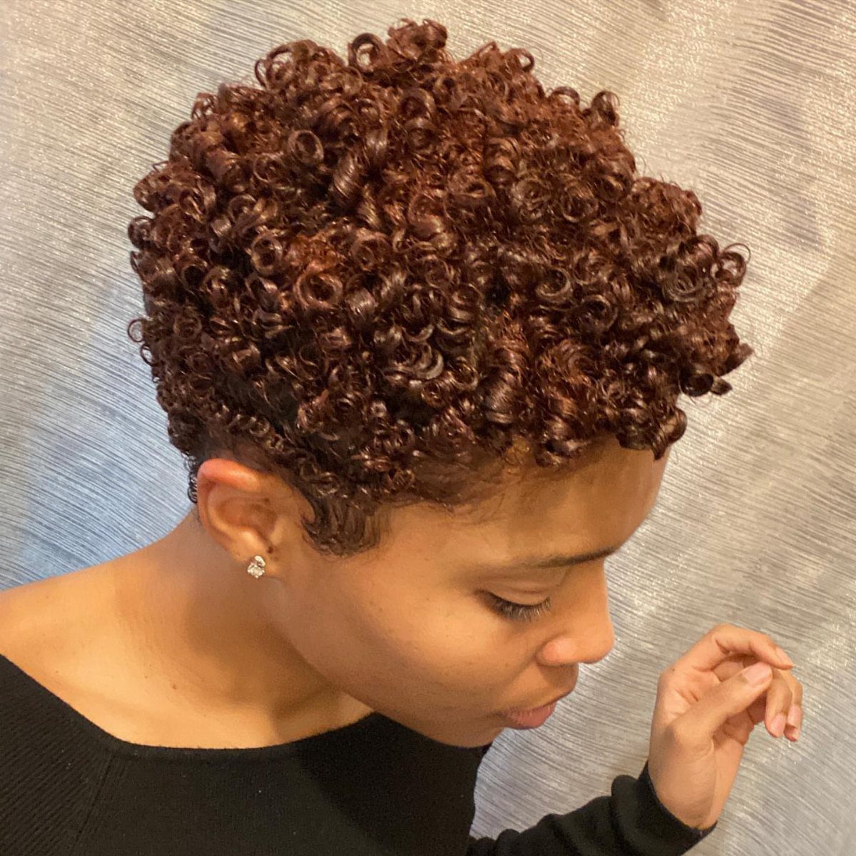 Short brown curly afro with dense coils and rounded volume