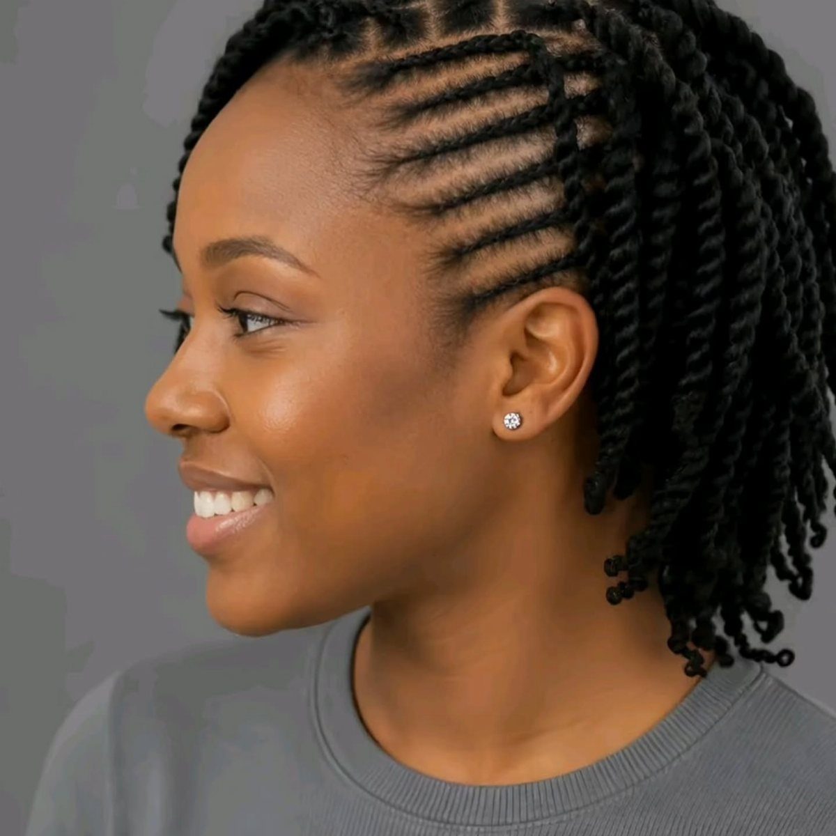 Woman with natural hair styled in neat scalp twists and longer twists